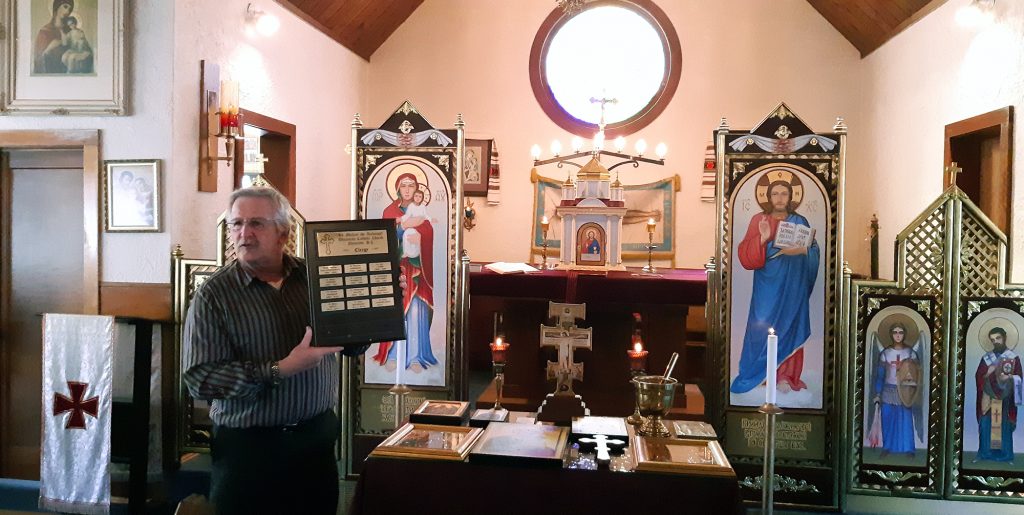 Victor Uniat presents clergy plaque