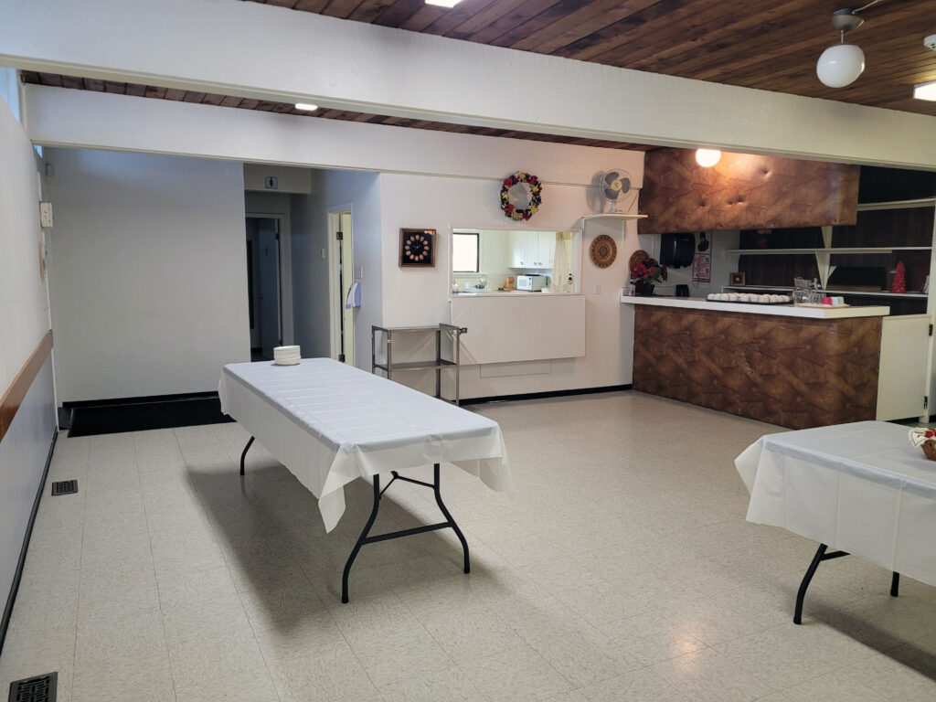 Saint Michael’s Parish Hall. Hall A, set up for buffet lunch, showing bare area and pass-through to kitchen.